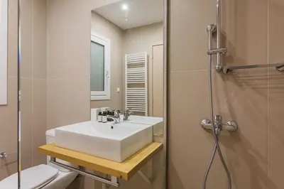a bathroom with a sink and a toilet and a shower at Groovy 2BR Apartment in Koukaki by UPSTREET in Athens
