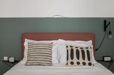 a bed with two pillows on top of it at Groovy 2BR Apartment in Koukaki by UPSTREET in Athens