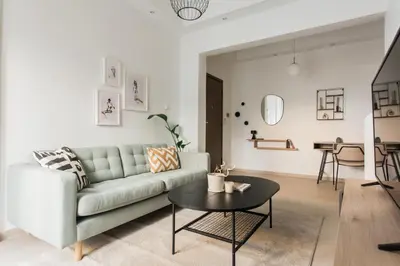 a living room with a couch and a table at Groovy 2BR Apartment in Koukaki by UPSTREET in Athens