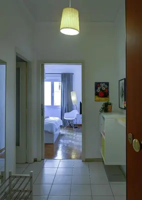 a room with a bedroom and a bed and a table at Sunny all day apartment near Athens city center in Athens