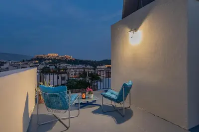 two chairs and a table on a balcony at Studio Acropolis Star in Athens