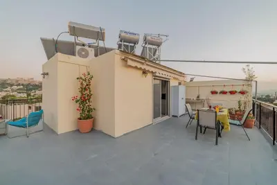 a patio with a table and chairs on a balcony at Studio Acropolis Star in Athens