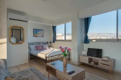 a bedroom with a bed and a living room at Studio Acropolis Star in Athens