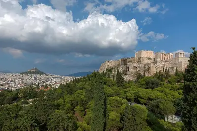 a view of a mountain with a city in the background at Acropolis Amazing Apartment with Parthenon view in Athens