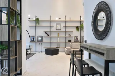 a living room with a table and chairs and a mirror at The Lop Athens Holidays Luxury Suites in Athens