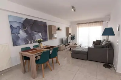 a living room with a table and chairs and a couch at Lovely 2-bedroom apartment with a city view (F10) in Piraeus