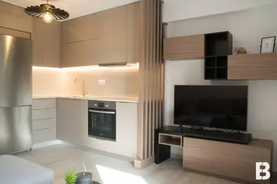 a kitchen with a sink and a television in it at Sia Mare in Kalívia Thorikoú