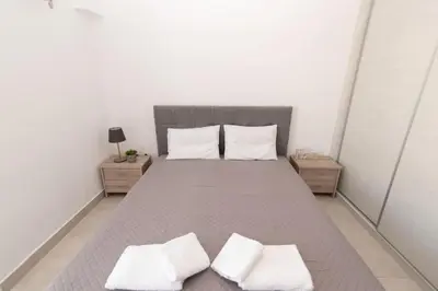 a bedroom with a bed with two white pillows at Comfy flat located in Piraeus (E7) in Piraeus