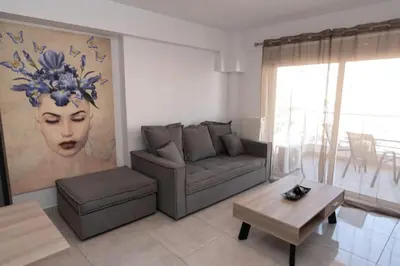 a living room with a couch and a table at Comfy flat located in Piraeus (E7) in Piraeus