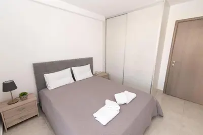 a bedroom with a bed with two white towels on it at Comfy flat located in Piraeus (E7) in Piraeus