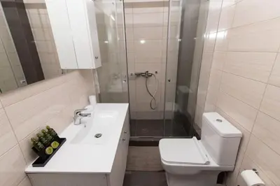 a bathroom with a toilet and a sink and a shower at Comfy flat located in Piraeus (E7) in Piraeus