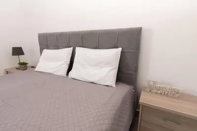 a bedroom with a bed with two pillows at Comfy flat located in Piraeus (E7) in Piraeus