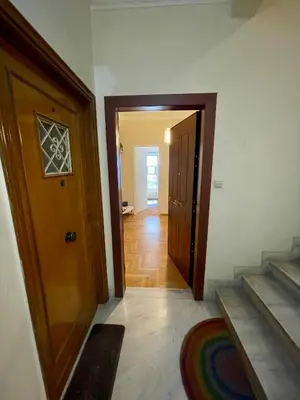 a hallway with a door and stairs in a house at Athens Spirit Apartment in Athens