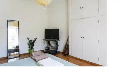 a living room with a couch and a tv at Central faliro Apartment near to marina in Athens