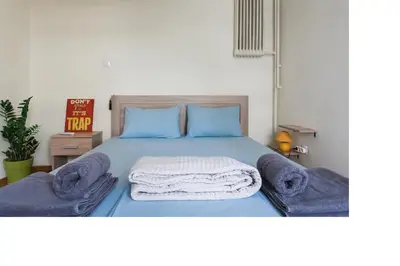 a bedroom with a bed with blue sheets and blue pillows at Central faliro Apartment near to marina in Athens
