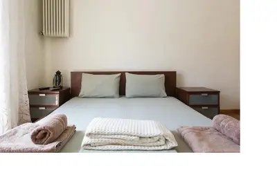 a bedroom with a bed with two towels on it at Central faliro Apartment near to marina in Athens