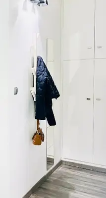a coat hanging on a wall in a room at Cozy Studio in Athens Riviera, next to SNFCC in Athens