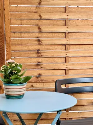 a blue table with a potted plant on top of it at Cozy Studio in Athens Riviera, next to SNFCC in Athens