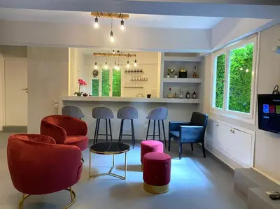a living room with chairs and a bar at Brand New Modern Street-Style STUDIO /CITY CENTER in Athens
