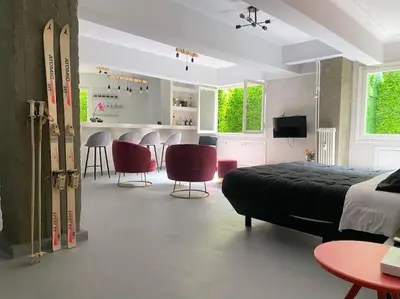 a bedroom with a bed and chairs and a kitchen at Brand New Modern Street-Style STUDIO /CITY CENTER in Athens