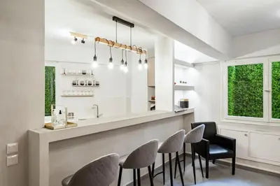 a dining room with a bar with chairs and a counter at Brand New Modern Street-Style STUDIO /CITY CENTER in Athens