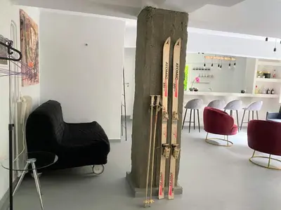 a room with skis on the wall and a room with chairs at Brand New Modern Street-Style STUDIO /CITY CENTER in Athens