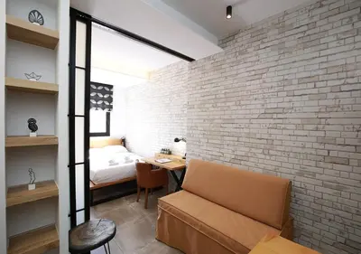 a room with a brick wall and a bedroom at Emily in Athens - Central design awarded flat Syntagma E3 in Athens