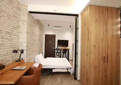 a bedroom with a bed and a desk and a table at Emily in Athens - Central design awarded flat Syntagma E3 in Athens