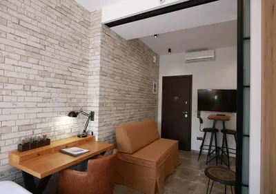 a room with a desk and a chair and a television at Emily in Athens - Central design awarded flat Syntagma E3 in Athens