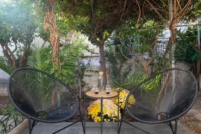 two chairs and a table with glasses on it at apt Eleven - cozy apartment with garden in Athens