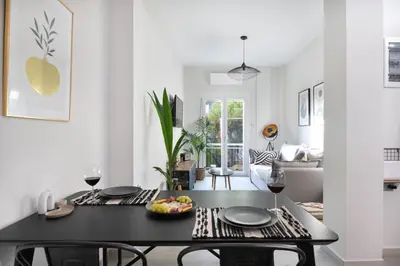 a living room with a table with a bowl of fruit on it at apt Eleven - cozy apartment with garden in Athens