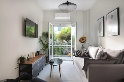 a living room with a couch and a table at apt Eleven - cozy apartment with garden in Athens