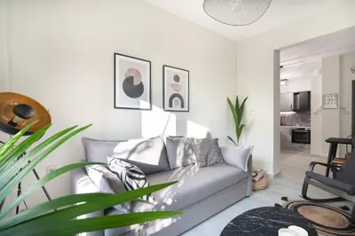 a living room with a couch and a chair at apt Eleven - cozy apartment with garden in Athens