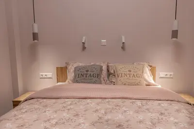 a bedroom with a large bed with two pillows at Elegant Apt 5' from Ampelokipi Metro Station in Athens