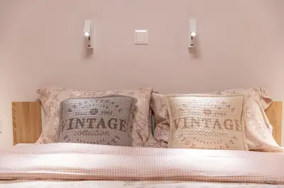 a bedroom with a bed with two pillows on it at Elegant Apt 5' from Ampelokipi Metro Station in Athens