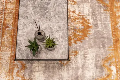 a clock on a wall with two plants on it at Elegant Apt 5' from Ampelokipi Metro Station in Athens