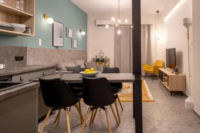 a kitchen and dining room with a table and chairs at Elegant Apt 5' from Ampelokipi Metro Station in Athens