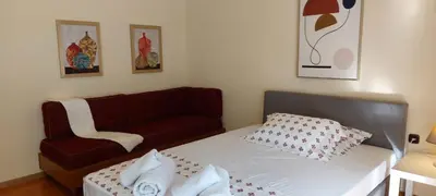 a small bedroom with a bed and a couch at Lobelia Athens Centre -5 BD, 2.5 BATH in Athens