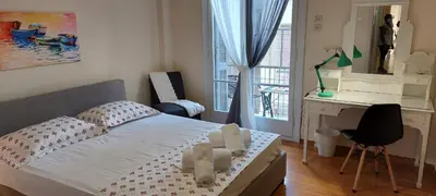 a small bedroom with a bed and a desk at Lobelia Athens Centre -5 BD, 2.5 BATH in Athens