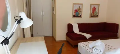 a living room with a red couch and a chair at Lobelia Athens Centre -5 BD, 2.5 BATH in Athens