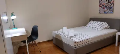a small bedroom with a bed and a desk at Lobelia Athens Centre -5 BD, 2.5 BATH in Athens