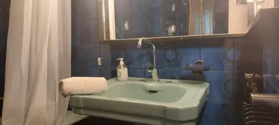 a bathroom with a green sink and a shower curtain at Lobelia Athens Centre -5 BD, 2.5 BATH in Athens