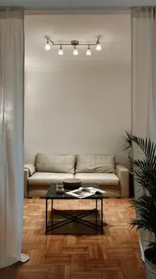 a living room with a couch and a table at Kolonaki Oasis in Athens