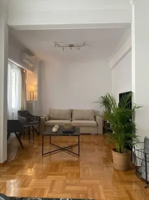 a living room with a couch and a table at Kolonaki Oasis in Athens