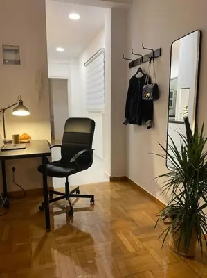 an office with a desk and a chair and a mirror at Kolonaki Oasis in Athens