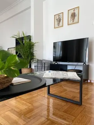 a living room with a coffee table and a tv at Kolonaki Oasis in Athens