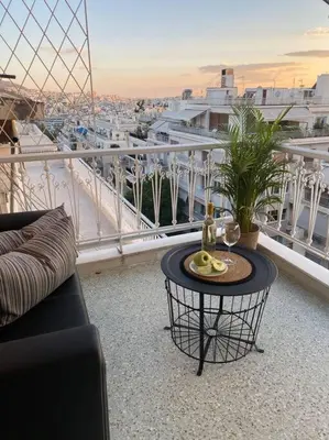 a balcony with a table and a view of a city at Kolonaki Oasis in Athens