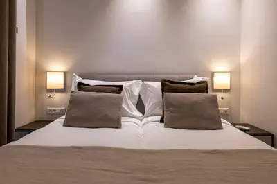 a bedroom with a white bed with two pillows at Phaedrus Living City Center Luxury Flat Neos Kosmos in Athens