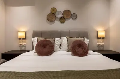 a bedroom with a bed with two pillows on it at Phaedrus Living City Center Luxury Flat Neos Kosmos in Athens