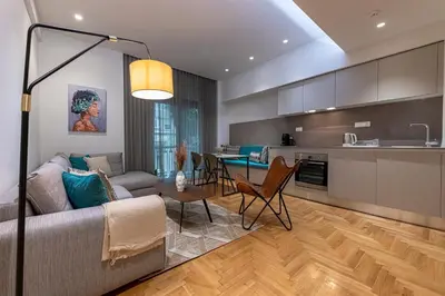 a living room and kitchen with a couch and a table at Phaedrus Living City Center Lux Flat Kolonaki in Athens